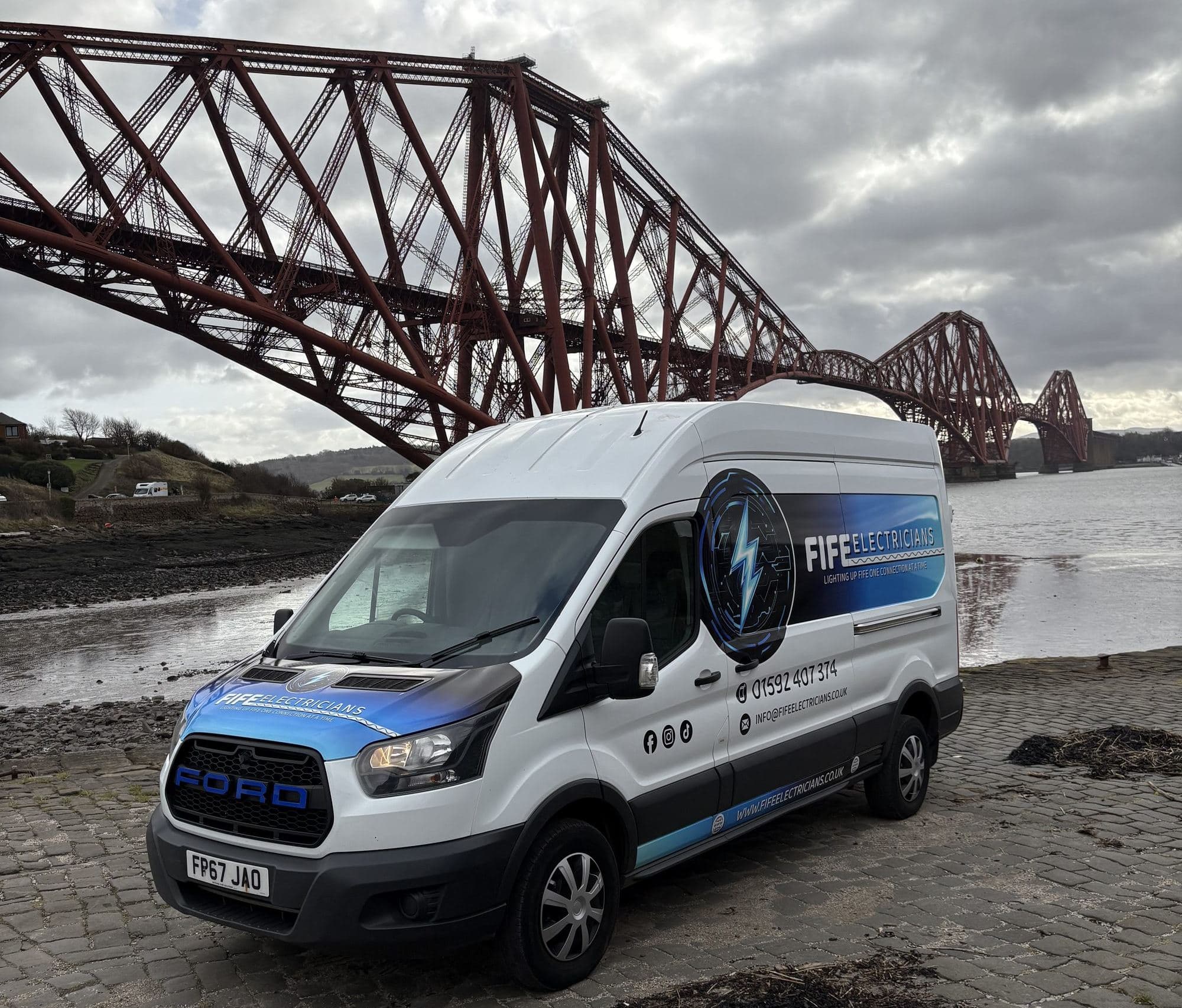 Fife Electricians branded van parked in front of the Forth Bridge